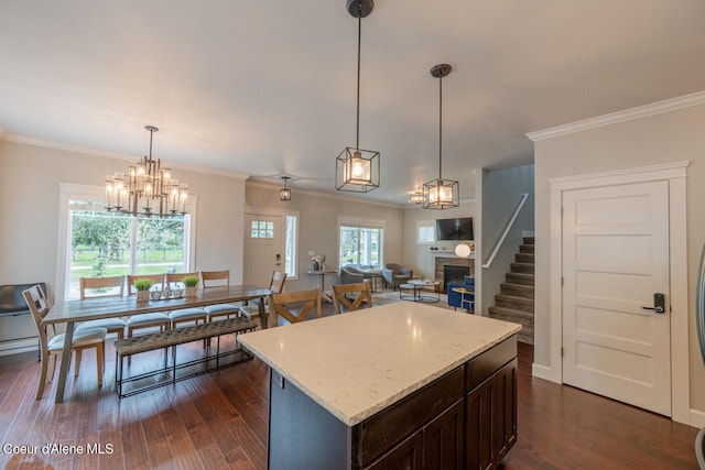 kitchen featuring ornamental molding, dark hardwood / wood-style flooring, an inviting chandelier, and decorative light fixtures