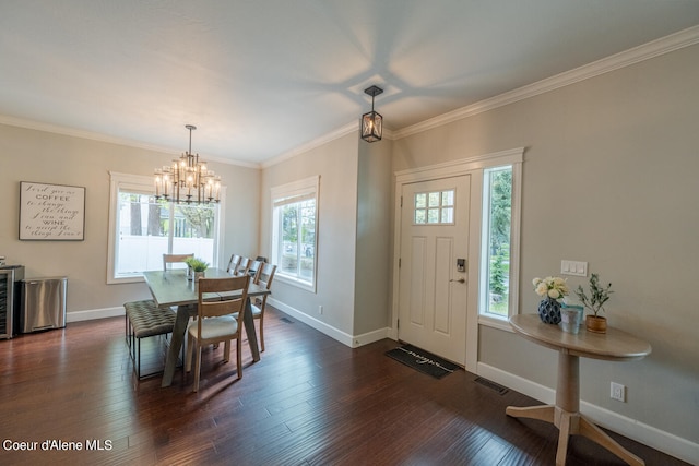 foyer entrance featuring crown molding, a chandelier, and dark wood-type flooring