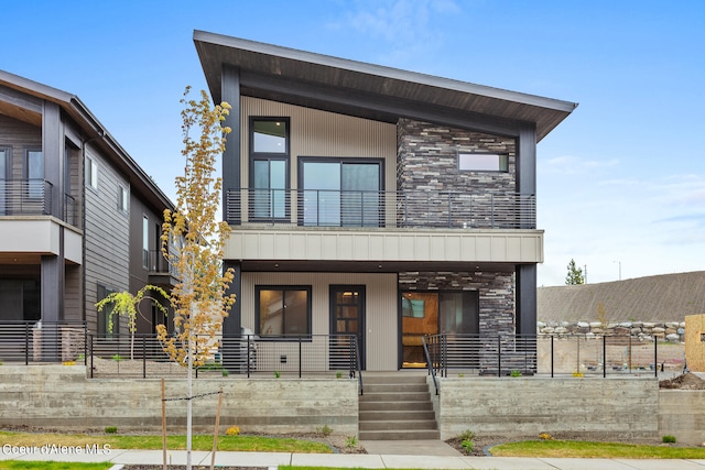 modern home featuring a balcony and a porch