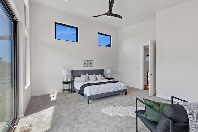 bedroom featuring light carpet and ceiling fan