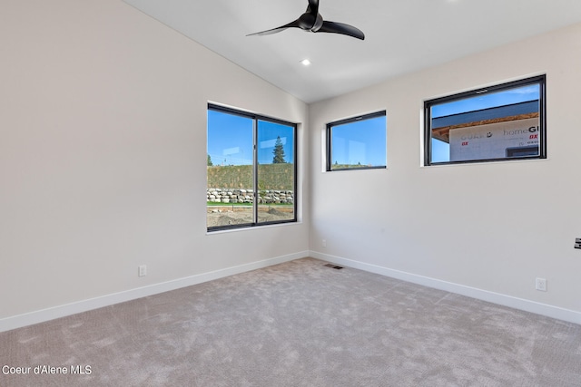 carpeted empty room featuring ceiling fan and lofted ceiling