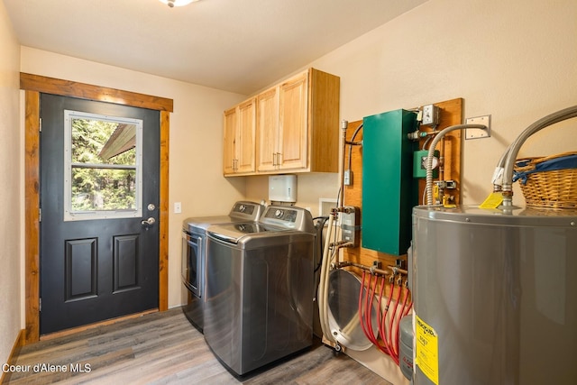 laundry area with independent washer and dryer, wood-type flooring, cabinets, and electric water heater