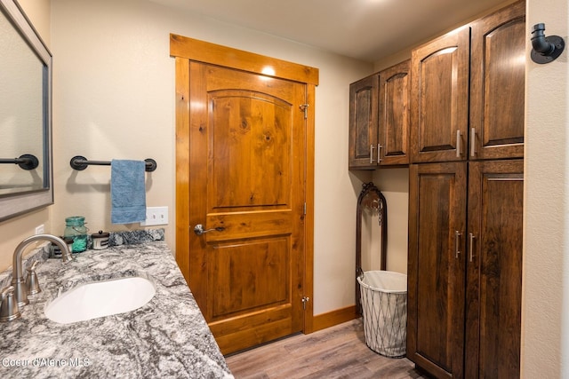 bathroom featuring oversized vanity and hardwood / wood-style flooring