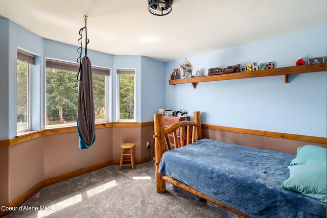 bedroom with carpet and a textured ceiling