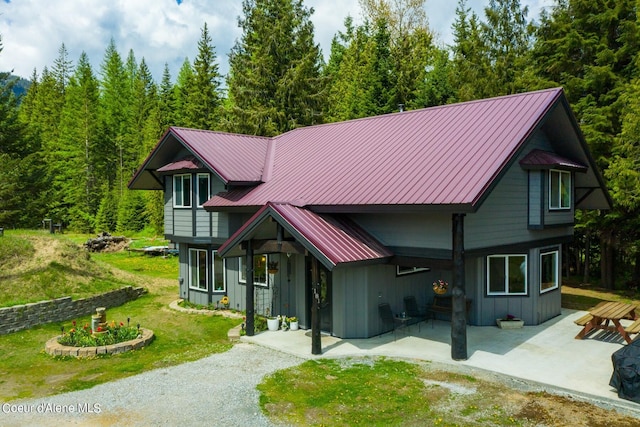 view of front of house featuring a front yard and a patio