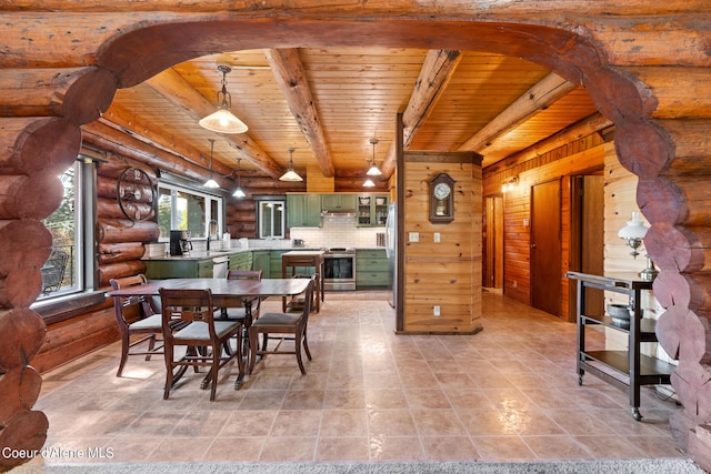 dining area featuring sink, wood ceiling, beamed ceiling, wooden walls, and light tile patterned floors