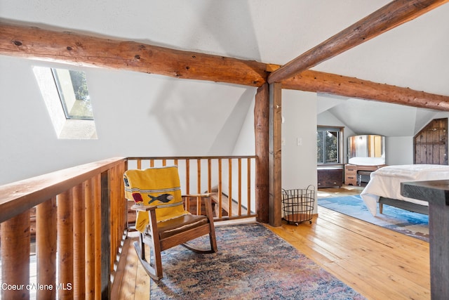 bedroom with light hardwood / wood-style flooring and lofted ceiling with skylight