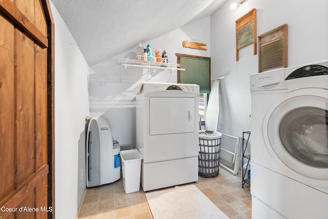 laundry area with a textured ceiling and a barn door