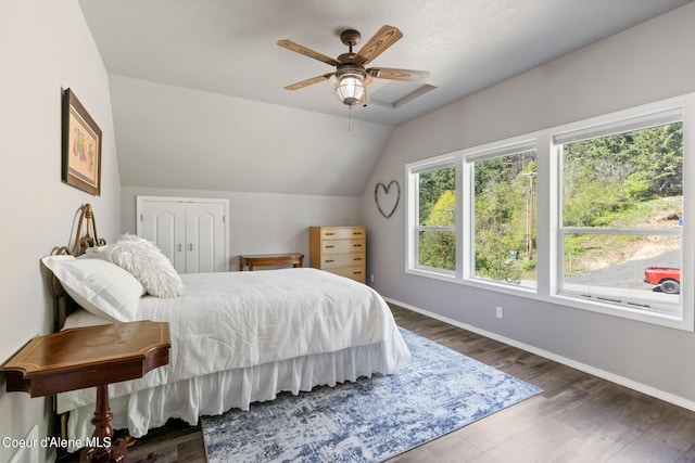 bedroom featuring a closet, ceiling fan, vaulted ceiling, and dark hardwood / wood-style flooring