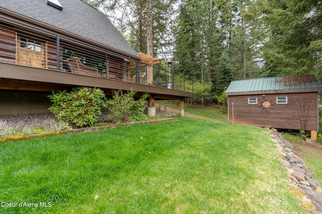 view of yard with a wooden deck and a storage unit