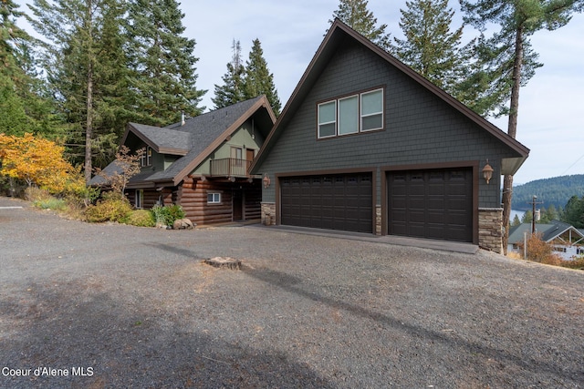 21651 S Lakeview Dr, Worley, ID 83876 - view of front of property with an attached garage, asphalt driveway, stone siding, and roof with shingles