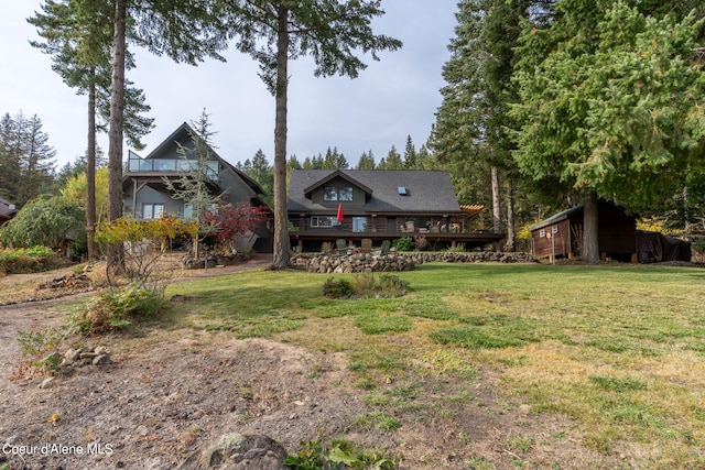 exterior space with a wooden deck and a front yard