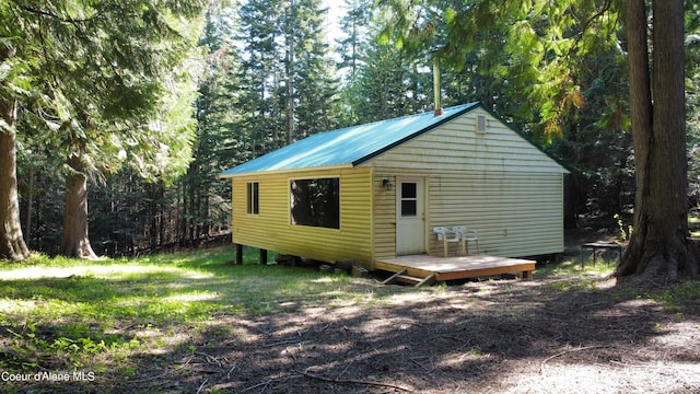 exterior space with a deck and an outdoor structure