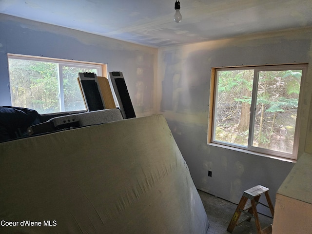 unfurnished bedroom featuring multiple windows