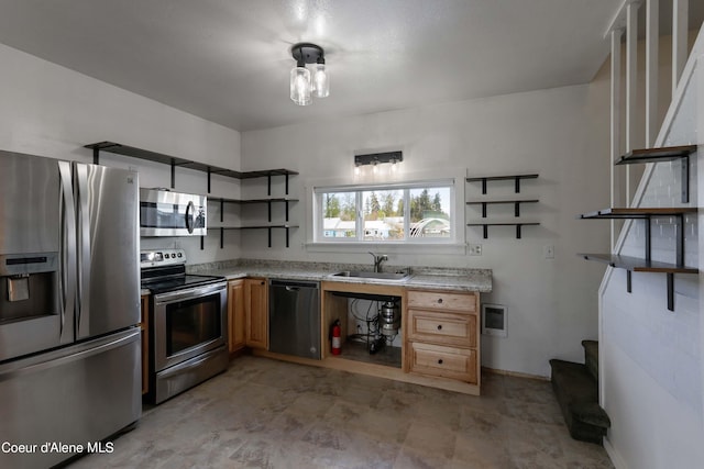 kitchen with appliances with stainless steel finishes, light stone counters, and sink