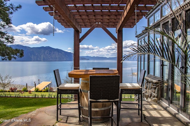 view of patio featuring a pergola and a water and mountain view