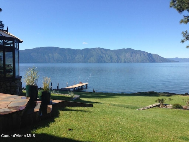 view of water feature with a mountain view and a dock
