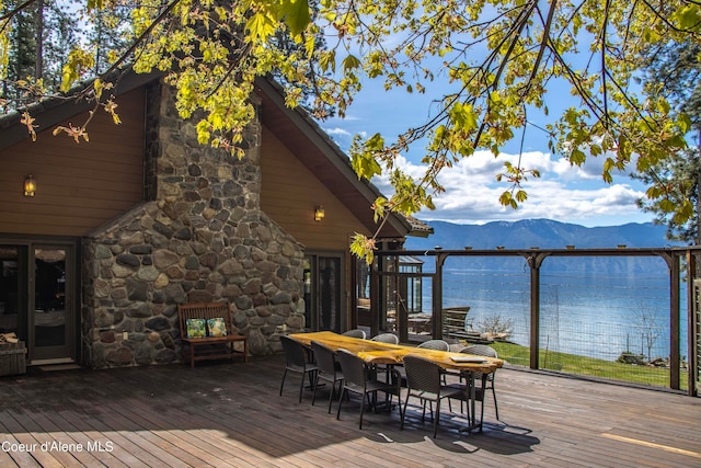 wooden deck featuring a water and mountain view