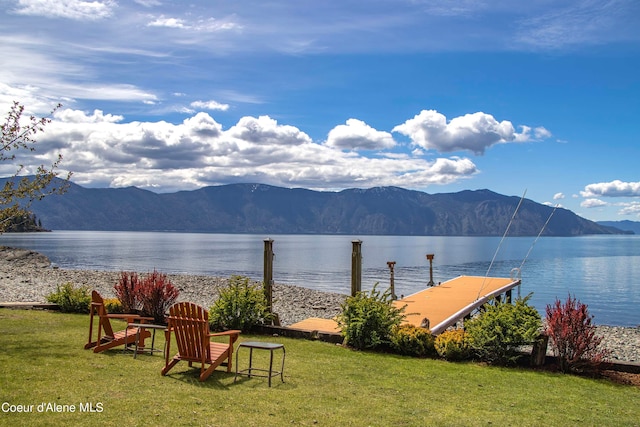 exterior space with a boat dock and a mountain view