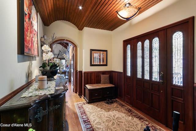 foyer with light hardwood / wood-style flooring and wooden ceiling