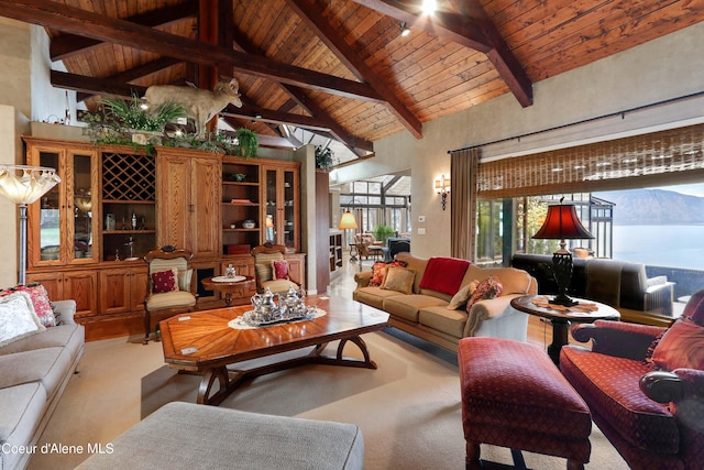 living room featuring high vaulted ceiling, beam ceiling, a mountain view, and wooden ceiling