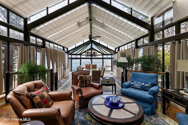 sunroom / solarium with a wealth of natural light, vaulted ceiling, and ceiling fan with notable chandelier