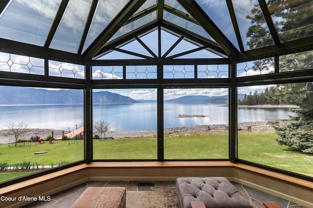 unfurnished sunroom with a water view and plenty of natural light
