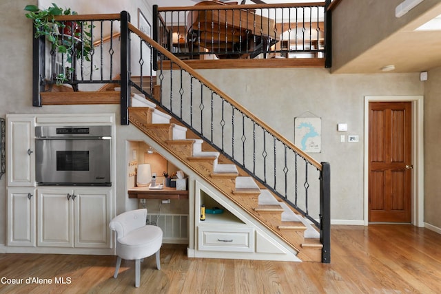 staircase featuring light wood-type flooring