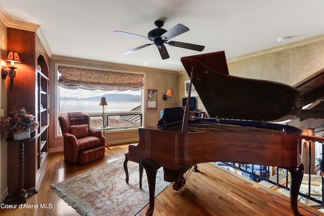 interior space featuring a wealth of natural light, ornamental molding, hardwood / wood-style flooring, and ceiling fan