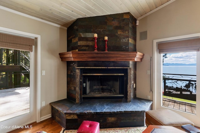 details with wooden ceiling, hardwood / wood-style flooring, ornamental molding, and a large fireplace