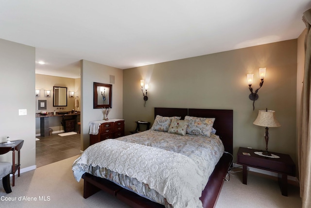carpeted bedroom with ensuite bath