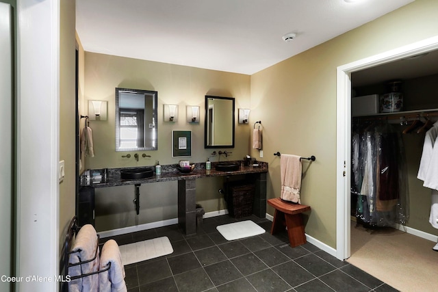 bathroom with dual bowl vanity and tile floors