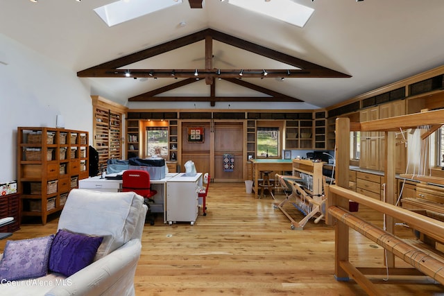 living room featuring vaulted ceiling with skylight and light wood-type flooring