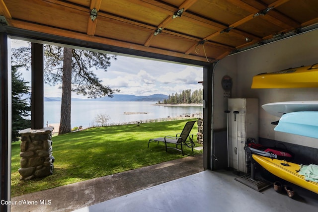 garage with a yard and a water view