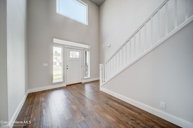 entrance foyer featuring a high ceiling and dark hardwood / wood-style floors