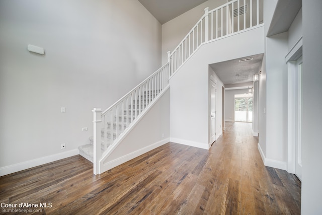 foyer featuring a high ceiling and hardwood / wood-style flooring