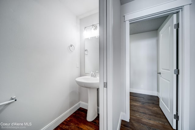 bathroom featuring a textured ceiling and hardwood / wood-style floors