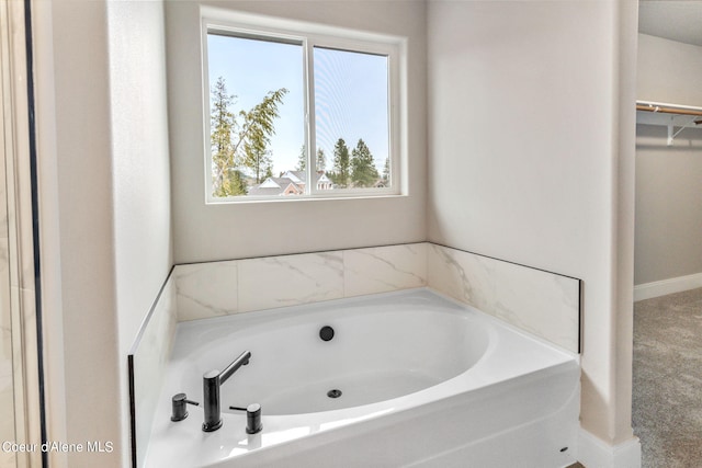 bathroom featuring a tub and a healthy amount of sunlight