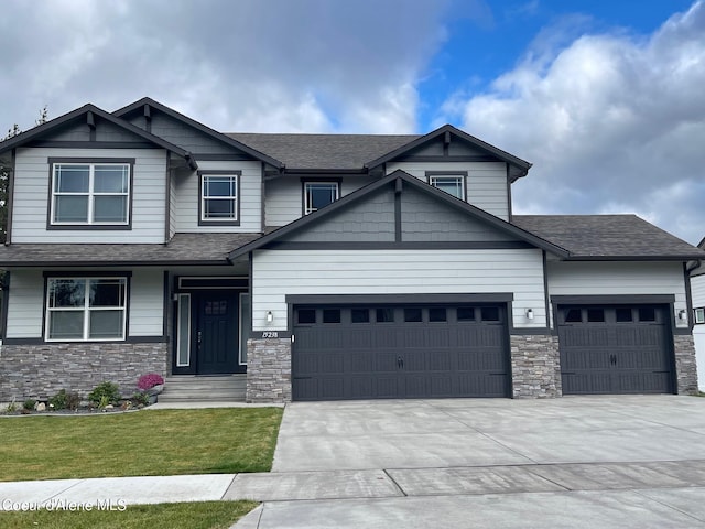 craftsman inspired home featuring a front lawn and a garage