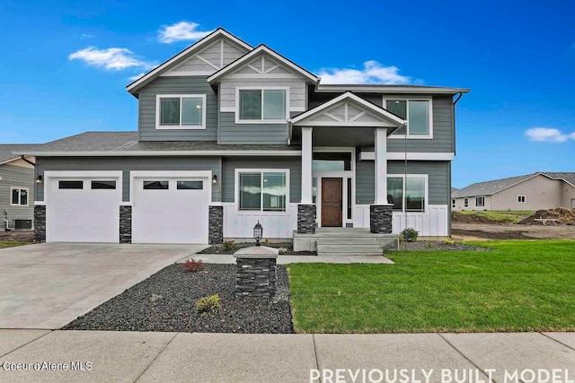 view of front of home with central AC, a front lawn, and a garage