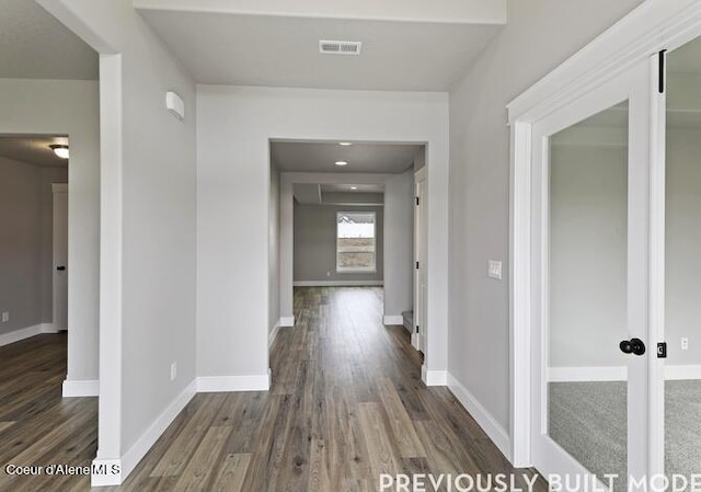 hall featuring dark hardwood / wood-style flooring and french doors