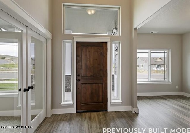 foyer with french doors and dark wood-type flooring