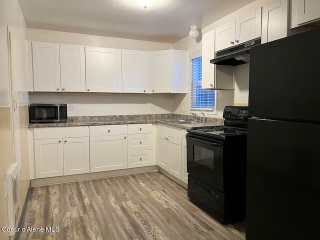 kitchen featuring black appliances, white cabinets, sink, and wood-type flooring