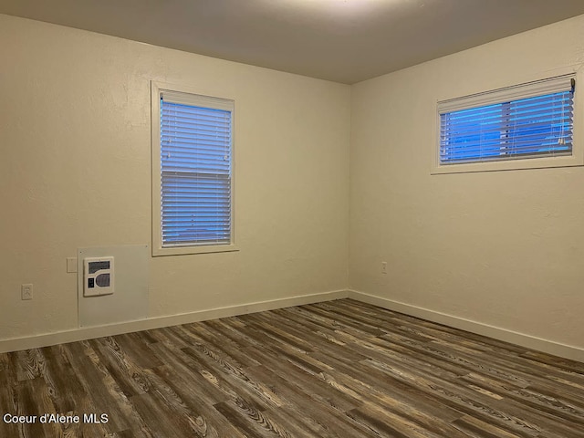 unfurnished room featuring dark hardwood / wood-style floors