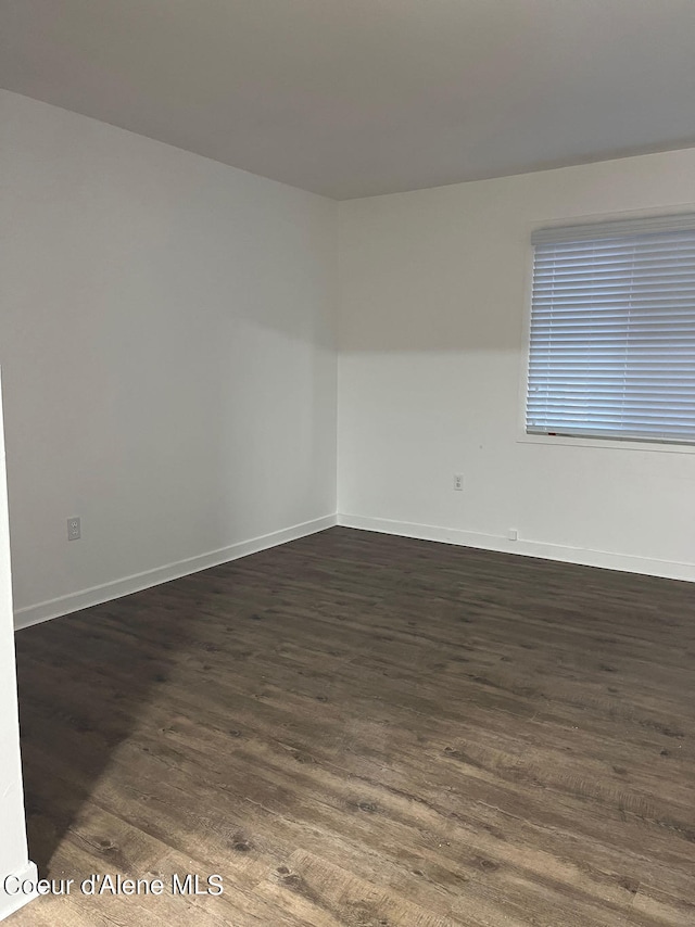 unfurnished room with dark hardwood / wood-style floors