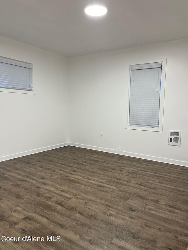 empty room featuring dark wood-type flooring