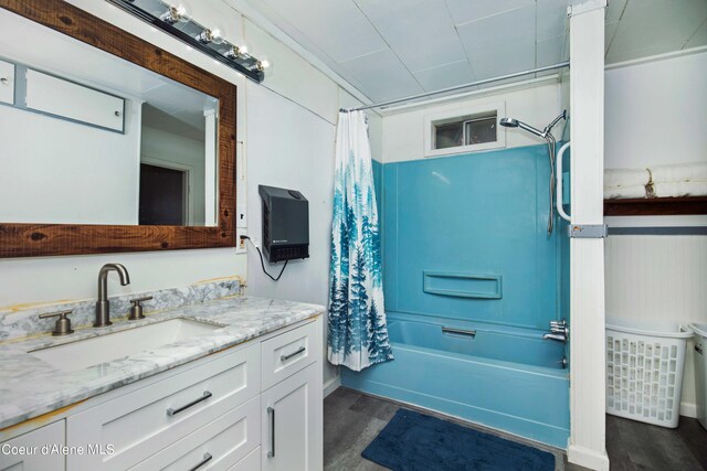 bathroom with oversized vanity, hardwood / wood-style flooring, and shower / bath combo with shower curtain