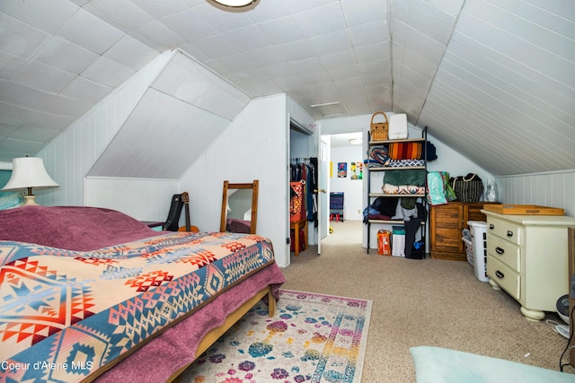 bedroom with lofted ceiling, carpet floors, and a closet