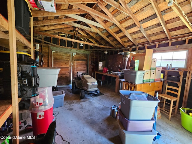 misc room with concrete flooring and vaulted ceiling