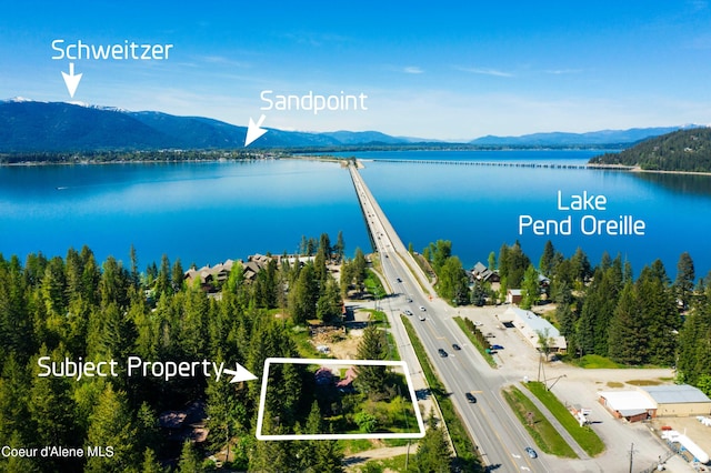 birds eye view of property featuring a water and mountain view